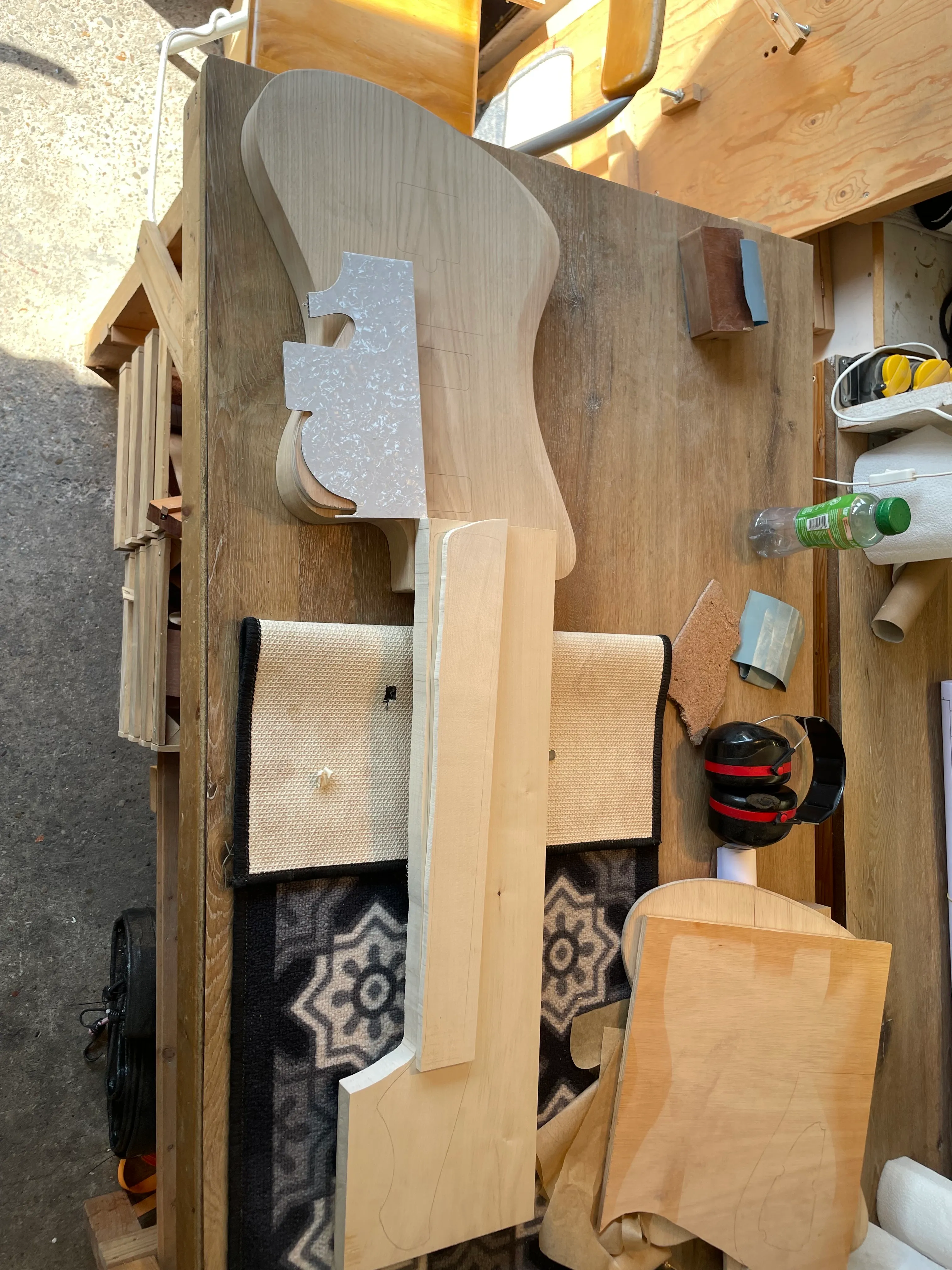 The guitar, neck, fretboard, and pickguard material arranged mostly where they will be if all goes well by the end.