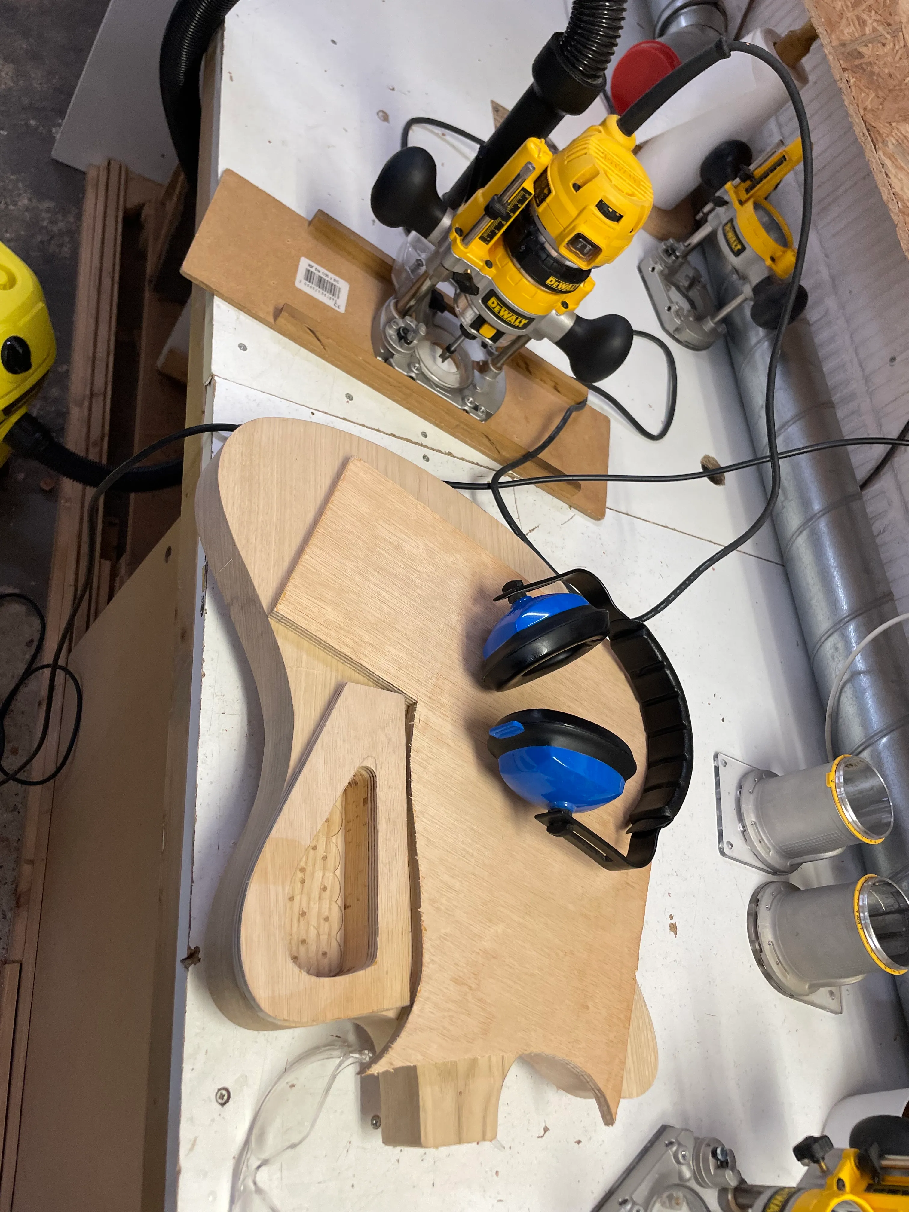 Using the plunge router is a bit nerve wracking, but this is how you get a control cavity. I have my template stuck to the front of the guitar and I’m using it as a guide.