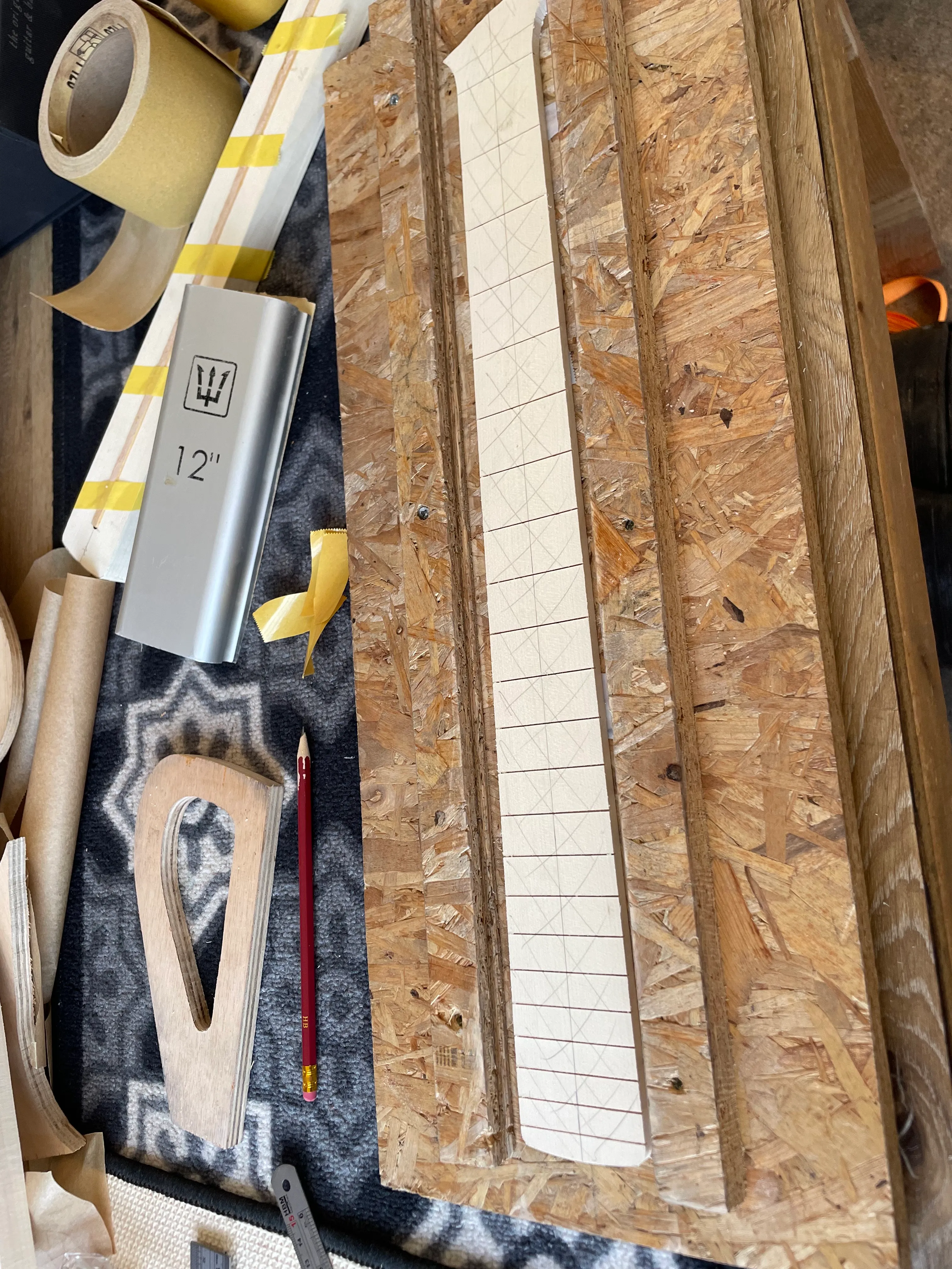 The fretboard is in a jig and I run a 12” radiused block over it until the pencil marks are gone.