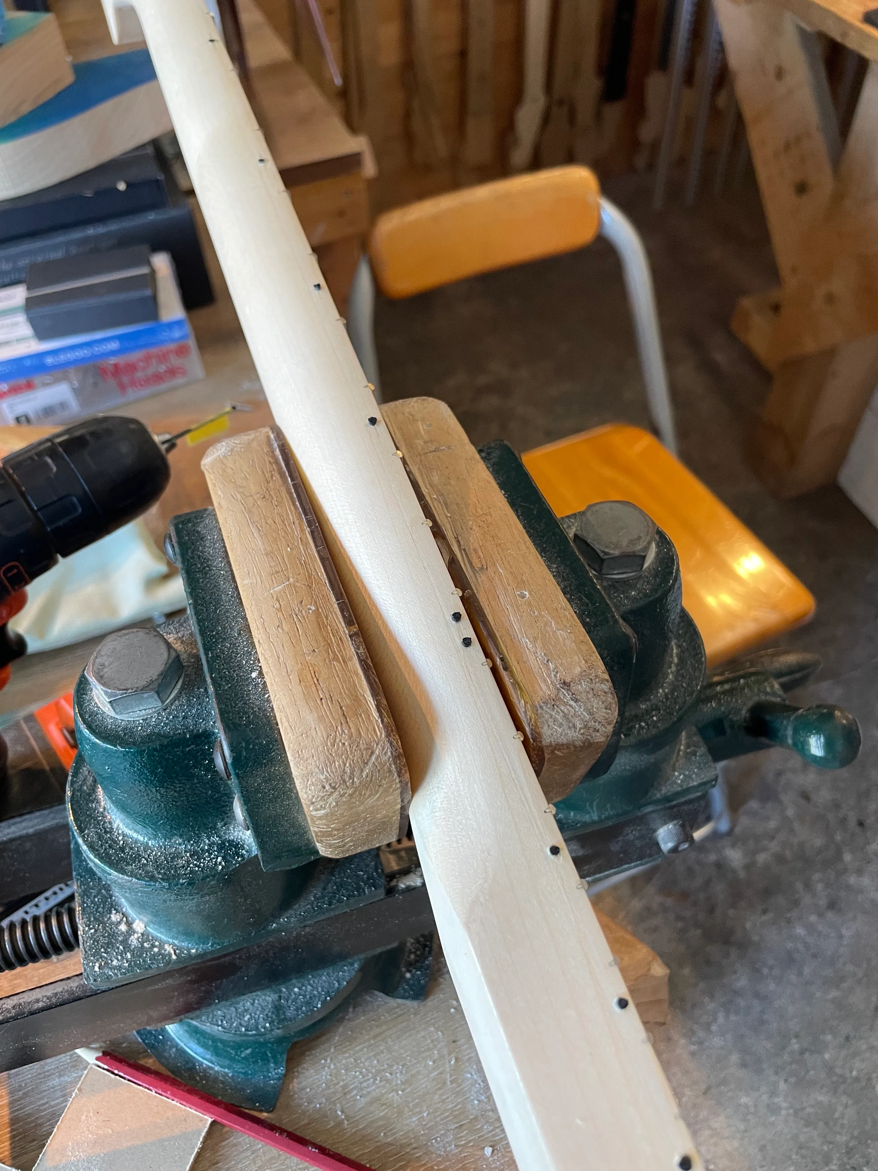 My neck is in the vice with glue setting on some black fret marker inlays on he side of the neck facing the player